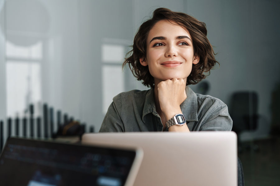 Womanonlaptop Smiling woman looking over laptop